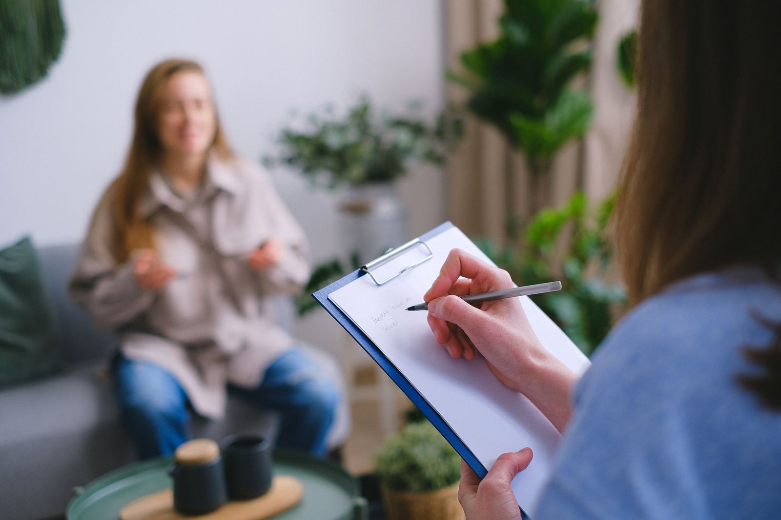 Nutrition specialist taking notes during a one-on-one gut health consultation